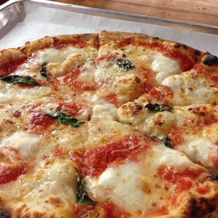 Margherita Pizza with bubbling cheese on a pan.