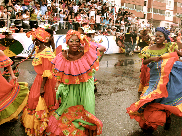 Dancers in colorful dresses at the Feria de Cali.